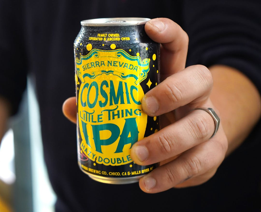 Cosmic Little Thing can in hand