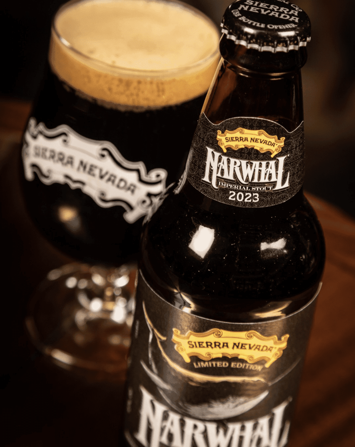 A close-up shot of a pint of Narwhal in a glass, sitting next to the bottle